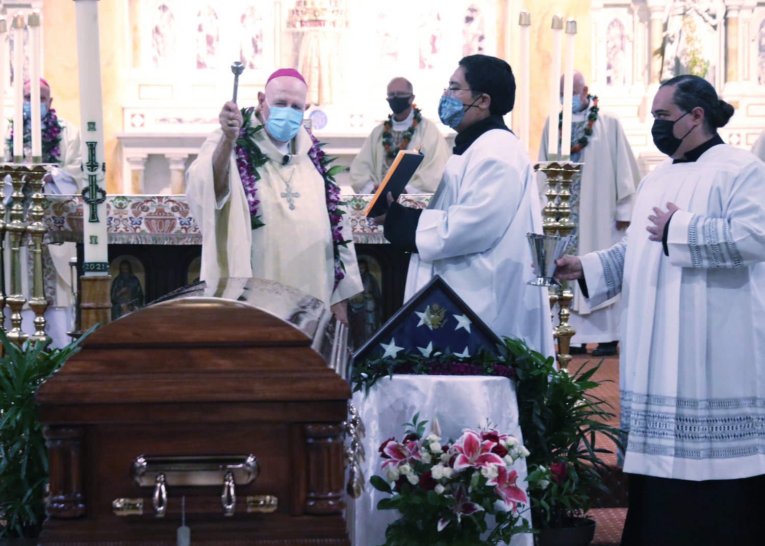Bishop Larry R. Silva of Honolulu blesses the casket of Father Emil J. Kapaun during a memorial Mass at the Cathedral Basilica of Our Lady of Peace in Honolulu Sept. 23, 2021. A candidate for sainthood, Kapaun died May 23, 1951, while ministering to prisoners of war during the Korean War. The priest's remains were being transferred from Punchbowl's National Cemetery of the Pacific to his home Diocese of Wichita, Kan.